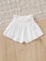 SHEIN Kids EVRYDAY Tween Girls' Woven Solid Color Loose Fit Casual Pleated Shorts