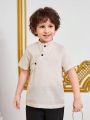 SHEIN Kids Nujoom Young Boy'S Irregular Placket Stand Collar Button Half-Open Shirt