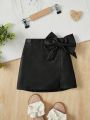 SHEIN Kids CHARMNG Girls' Comfortable Solid Color Pu Skirt With Bow Decoration For Casual Occasions