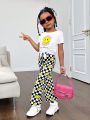 SHEIN Kids Cooltwn Street-Style Young Girl's Cool Knitted Round Neck Short Sleeve Top With Face Design And Checkerboard Flare Pants Set, Spring/Summer