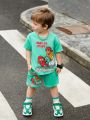 SHEIN Young Boy Cute And Comfortable Surfer Character Pattern Short-Sleeved Top And Shorts Set