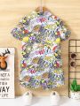 SHEIN Kids QTFun 2pcs Young Boys' Cartoon Printed Short Sleeve Shirt And Shorts Set, Casual & Stylish Streetwear For Spring/Summer