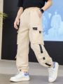 SHEIN Kids KDOMO Tween Girls' Side Stripe Cargo Pockets Relaxed Fit Long Pants