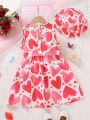SHEIN Kids CHARMNG Little Girls' Sleeveless Love Heart Printed Dress With Belt And Hat, Spring/Summer
