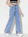 Teen Girl's New Casual Fashionable Distressed Straight Leg Jeans With Asymmetrical Button Fly And Slit Hem, In Washed Denim