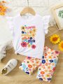 SHEIN Kids EVRYDAY Toddler Girls' Floral Printed Flying Sleeve Top With Slogan & Cycling Shorts Set