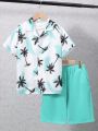 SHEIN Kids SUNSHNE Boys' Tropical Print Resort Wear Camp Collar Short Sleeve Woven Shirt & Solid Knit Shorts Set
