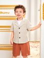 SHEIN Kids Nujoom Young Boy's Cute Turn Down Collar Short Sleeve Shirt And Shorts Set