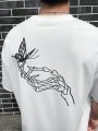 Manfinity EMRG Loose Fit Men's Skull Hand & Butterfly Pattern Print Short Sleeve Casual T-Shirt