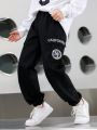 SHEIN Kids FANZEY 2pcs/Set Tween Boys' Letter Printed Flap Pocket & Side Striped Workwear Pants