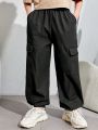 SHEIN Kids EVRYDAY Tween Boys' Casual Resort-Style Loose Woven Trousers With Letter Patch And Three-Dimensional Patch Pockets.