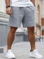 Manfinity Homme Men's Solid Color Elastic Waistband Shorts With Diagonal Pockets